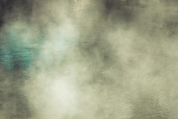 Background image of steam rising above a hot water thermal pool