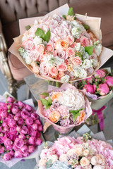 Vases with different colored flowers, showcase flower shop. Beautiful spring bouquets. . Small family business. Work florist. copy space