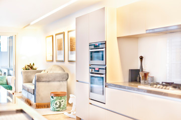 Fototapeta na wymiar Luxury kitchen oven and pantry cupboards beside sofa