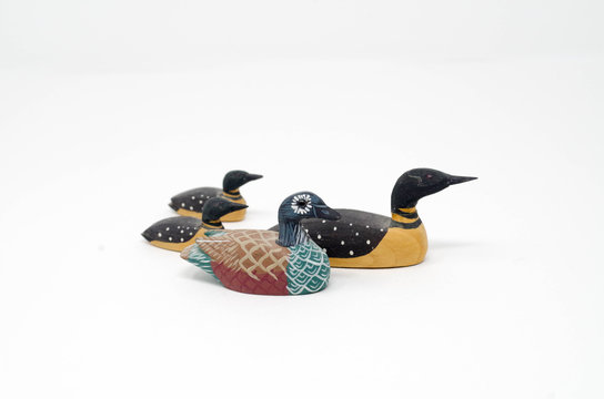 Four miniature handcarved and painted duck decoys