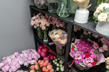 Vases with different colored flowers, showcase flower shop. Beautiful spring bouquets. . Small family business. Work florist. copy space