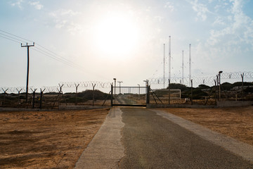 Barbed wire fence block the way. gate to a closed area. Automatic metal gate