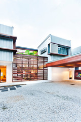 Stone floor entrance through the wooden gate to a factory