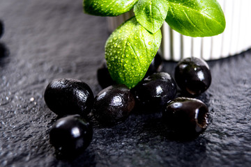 Black olives on black stone