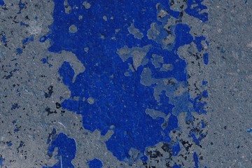 Toned asphalt surface with paint on it close up. Abstract background