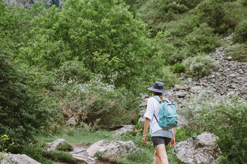Young lady tourist hiking in the mountains of Georgia