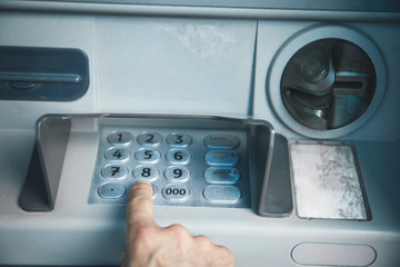 Man hand pressing on ATM machine keypad. ATM. Withdraw money