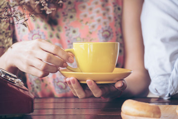 Woman hands holding cup of coffee in the morning