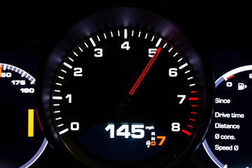 Modern light car mileage on black background