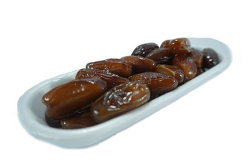 stack of dates in a white container