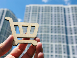 Buy new apartments or property. Shopping card and house.