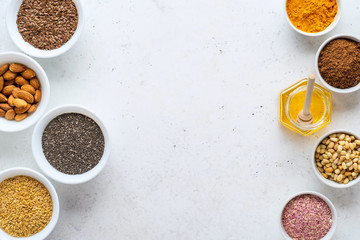 Healthy super food clean eating selection (seeds, powder turmeric, carob, nuts, honey, dried beet)