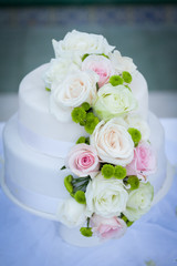White wedding cake with real roses