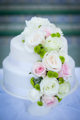 White wedding cake with real roses