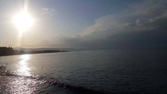 Amazing Paradise lake Sevan, at a beautiful sunset in peacetime, on the picturesque resort beach of the city of Martuni of Armenia, a place of rest and tourism