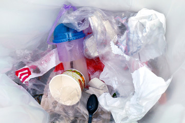top view of plastic bottle water drink waste and straws in recycle bin dirty, pile of garbage...