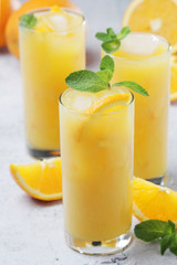 Glasses full of orange juice with ice