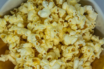 Popcorn is a snack made from corn kernels it is white color popular for people in many countries.