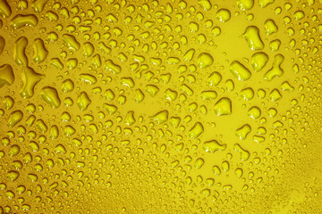 The Abstract water drop on surface of  fresh yellow background