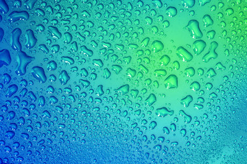 The Abstract water drop on surface of  fresh blue background