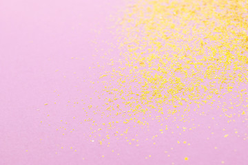Golden sparkles on pastel pink background. Stylish abstract minimalistic image.