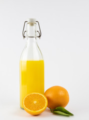 Fresh healthy orange juice in a glass bottle on white background. summer concept.
