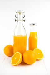 Fresh healthy orange juice in a glass bottle on white background. summer concept.