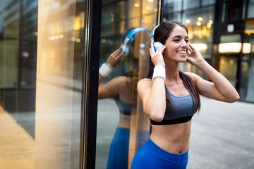 Portrait of happy fit woman in city. Healthy lifestyle concept