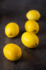 yellow fragrant lemons on a dark table