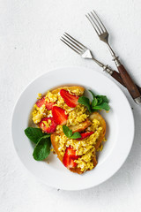 Sandwiches with scrambled eggs and strawberry. Delicious breakfast or snack on a dark background, top view. Flat la