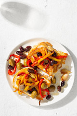 Sandwiches with grilled peppers, olives and garlic on a light background, top view. Flat lay