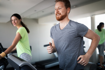 Fototapeta na wymiar People running on a treadmill in health club