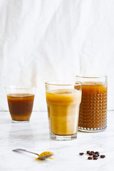 Iced coffee with cream and vanilla in various glasses on white background. Summer cocktail or dessert