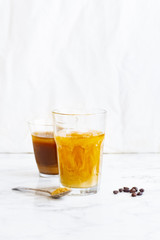 Iced coffee with cream and vanilla in various glasses on white background. Summer cocktail or dessert