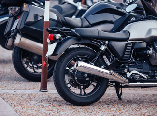 Fototapeta na wymiar Rent row black scooter motorbikes standing in parking lot