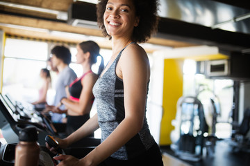 Fototapeta premium Picture of cheerful fitness team in gym