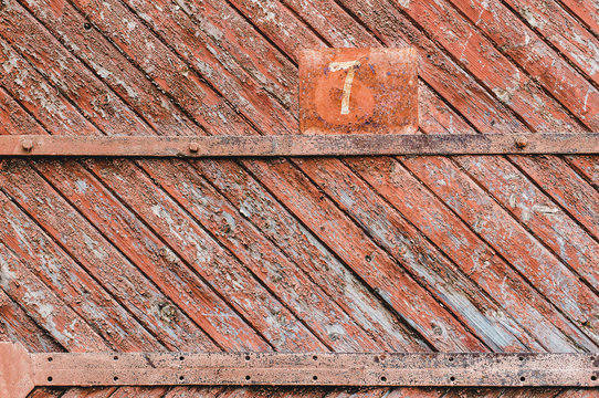 Old background with scabby paint, orange paint and a figure seven