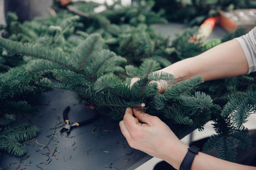 Christmas tree wreath decoration with woman hand workshop DIY