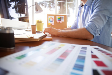 Graphic design and color swatches and pens on a desk. Architectural drawing with work tools and...