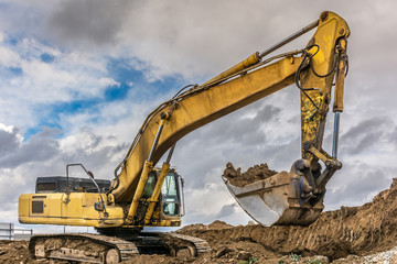 An excavator extracting dirt in a construction site