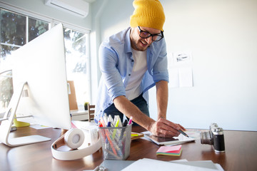 Graphic Designer working with interactive pen display, digital Drawing tablet and Pen on a computer.