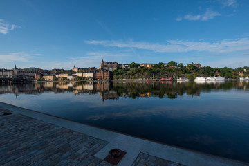 Boats, pier and landmarks in Stockholm a tranquil morning, 