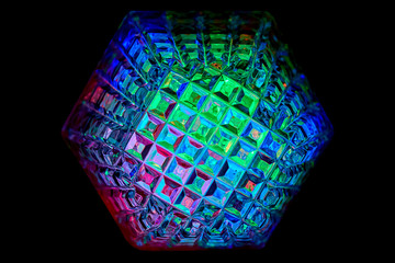 Multicolored rays of light shine through crystals with hexagonal faces