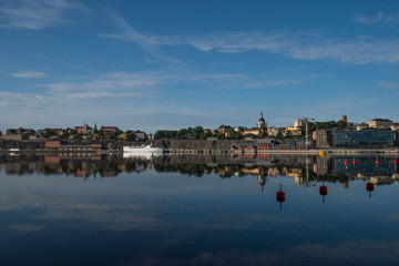 Obraz premium Boats, pier and landmarks in Stockholm a tranquil morning, 