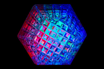 Multicolored rays of light shine through crystals with hexagonal faces