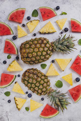 Summer background with portions of pineapple and watermelon