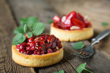 Cakes with fresh berries and mint leaves