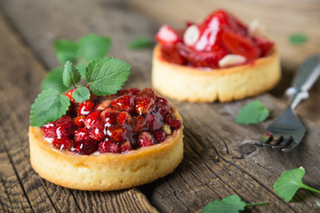 Cakes with fresh berries and mint leaves