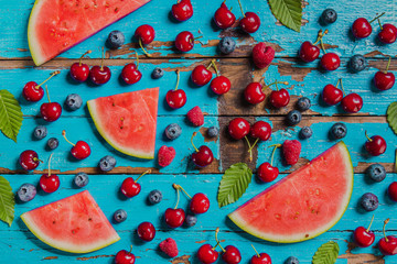 Old surface with blueberries, cherries and watermelon portions