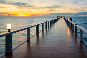 Fototapeta premium Wooded bridge in the port at sunset.